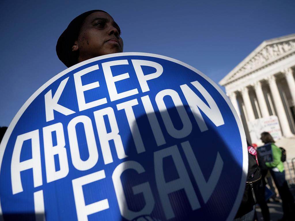 A pro-choice activist holds a sign as she counter-protests in front of the US Supreme Court during the 2018 March for Life in Washington, DC. Picture: AFP