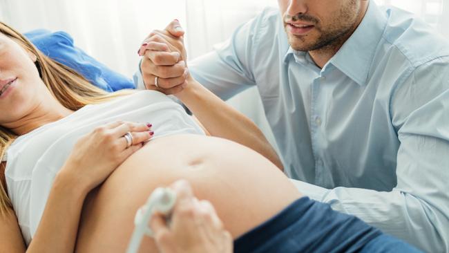 Ultrasound Examination In Doctors Office. Woman and her man in doctors office doing ultrasound examination  Picture: Istock