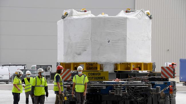 Engineers stand next to the world's most powerful magnet as it is delivered at the international nuclear fusion project Iter in Saint-Paul-les-Durance, southern France, on September 9. Picture: AFP