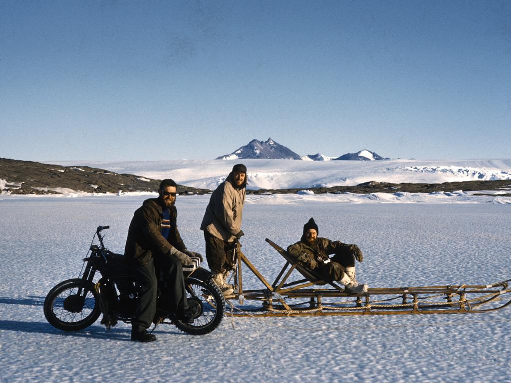 George Cresswell on the 350cc Velocette motorbike with Doug Machin and Viv Hill on the dog sled on the sea ice near Mawson. Picture: Jim Kitchenside