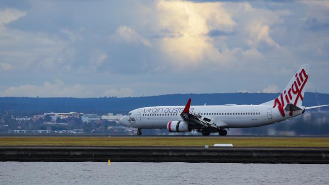 A Virgin plane lands at Sydney Domestic Airport. Picture: NCA NewsWire / Gaye Gerard