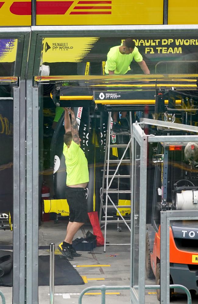 Team members pack up in the garage of Australian F1 driver Daniel Ricciardo at Albert Park – where the 2020 Australian Grand Prix was to be held. Picture: AAP