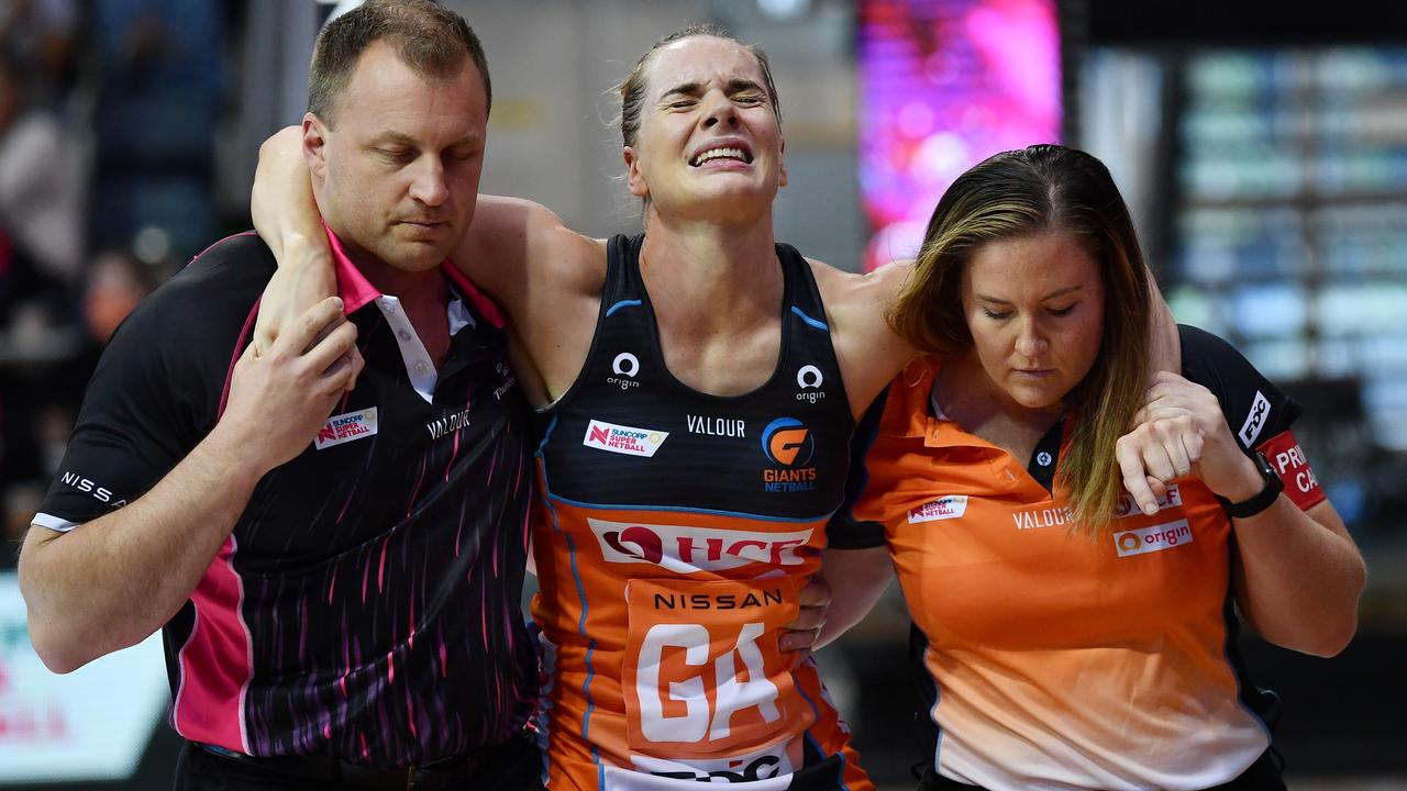 Kiera Austin is helped off the court after injuring her knee during the round one Super Netball match between Adelaide Thunderbirds and GWS Giants in May 2021. Picture Getty Images