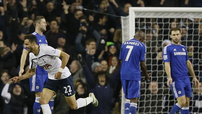 Chelsea players stand dejected as Tottenham's Nacer Chadli celebrates.