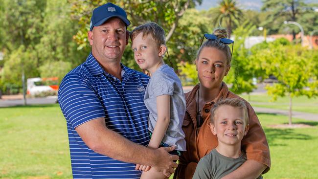 Dale and Lauren Smedley with their children Reid and Logan. The family say failure to turn up Logan’s cochlear implants over four years caused delays in his hearing and speech. Picture: Ben Clark