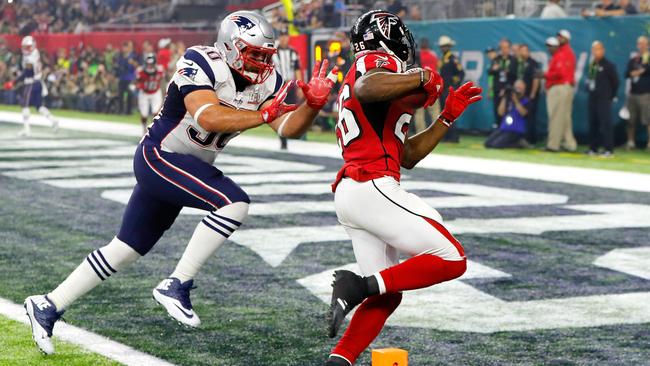 Tevin Coleman carries the ball past Rob Ninkovich for a six-yard touchdown. Picture: Getty