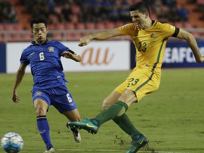 Sarach Yooyen of Thailand, left, and Tom Rogic of Australia battle.