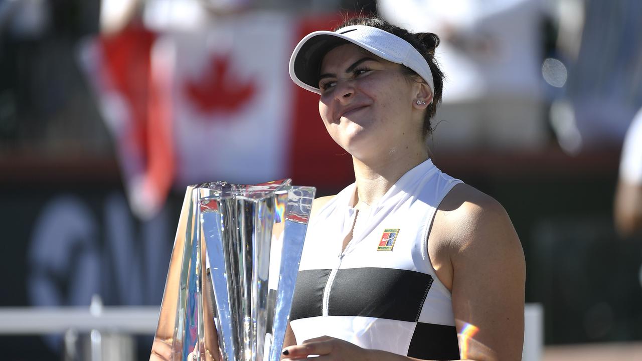Bianca Andreescu of Canada poses with the championship trophy.