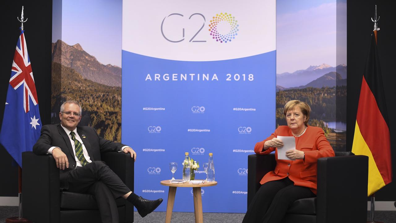 Angela Merkel clutched her notes rather protectively as she sat with the Australian leader.