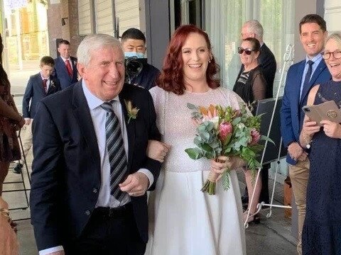 Steve Mortimer walks his daughter Erin down the aisle.