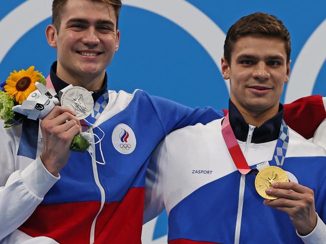 TOKYO, JAPAN - JULY 27: Silver medalist Kliment Kolesnikov of Team ROC, gold medalist Evgeny Rylov of Team ROC and bronze medalist Ryan Murphy of Team United States pose during the medal ceremony for the Men's 100m Backstroke Final on day four of the Tokyo 2020 Olympic Games at Tokyo Aquatics Centre on July 27, 2021 in Tokyo, Japan. (Photo by Tom Pennington/Getty Images)