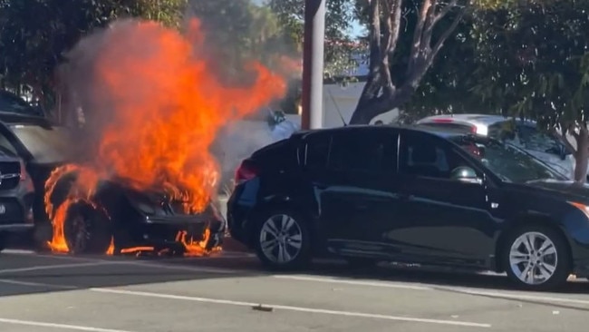 A car has exploded after catching fire in the Runaway Bay Shopping Centre car park. Picture: Calvin Swain