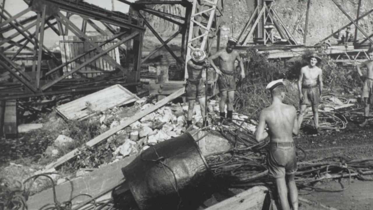 Bombing of Darwin: Riggers at the Royal Australian Navy Boom Defence Yard,preparing to launch a section of the anti-submarine netting down a chute alongside the BoomWharf.