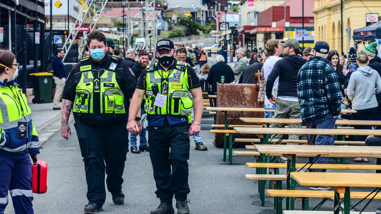 Masked security guards walking Queenstown's main St to ensure conformity as the Unconformity Festival was cancelled. Picture: Chris Crerar