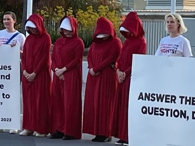 Protesters gather outside the venue for the Sky News/Courier-Mail People's Forum in Brisbane.