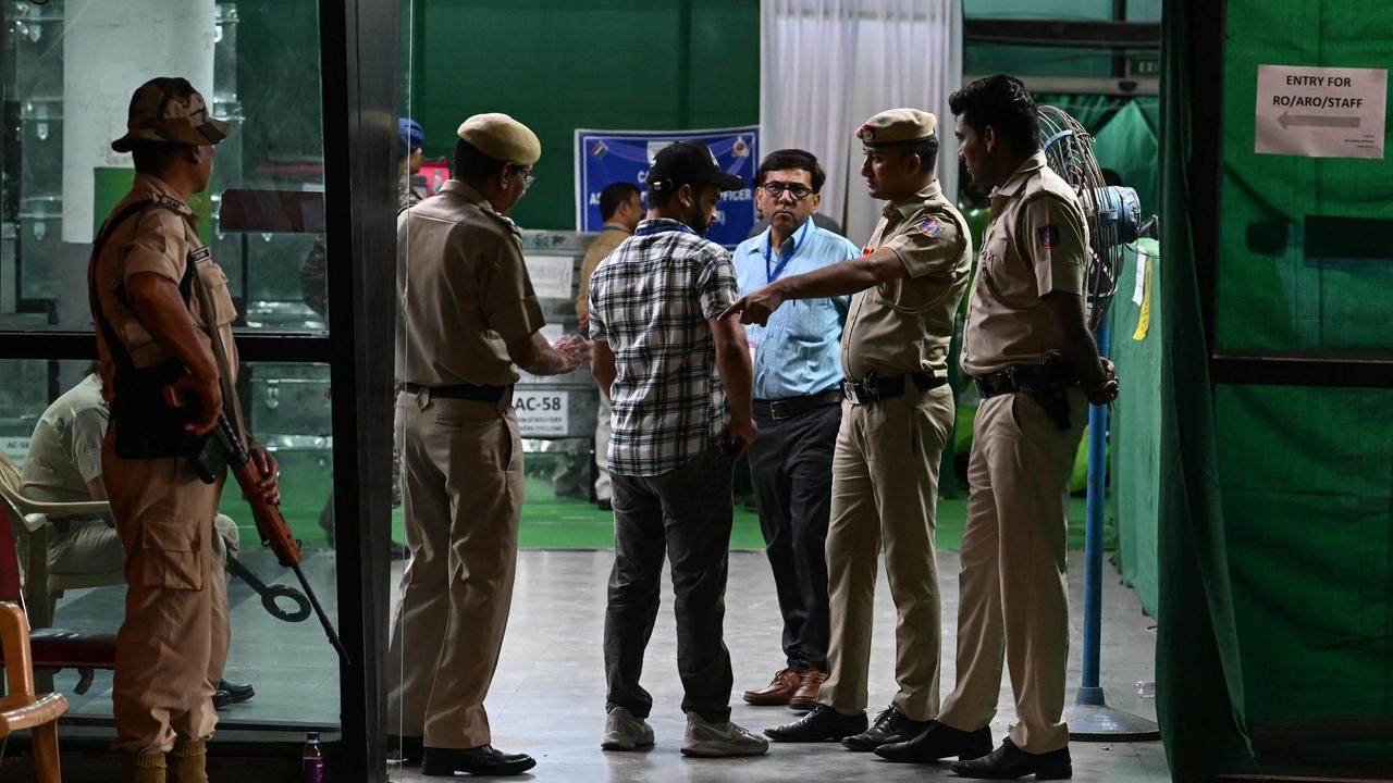 Security personnel inspect a man entering an election vote counting station in New Delhi on June 4, 2024. Picture: AFP