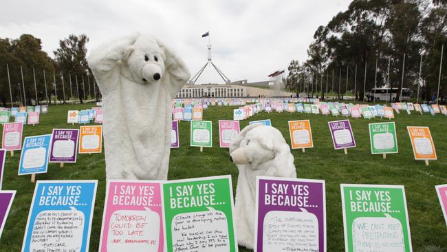 Placards spelling out Say Yes to Clean Energy, on the lawn outside Parliament House in Canberra to encourage politicians to vote ’yes' to a price on carbon pollution.