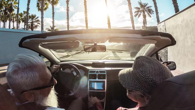 Senior trendy couple inside a convertible car - Mature people having fun doing a road trip in a tropical place - Travel, fashio and joyful elderly concept - Main focus on woman hatEscape 5 Novemeber 2023Doc Holiday Photo - iStock