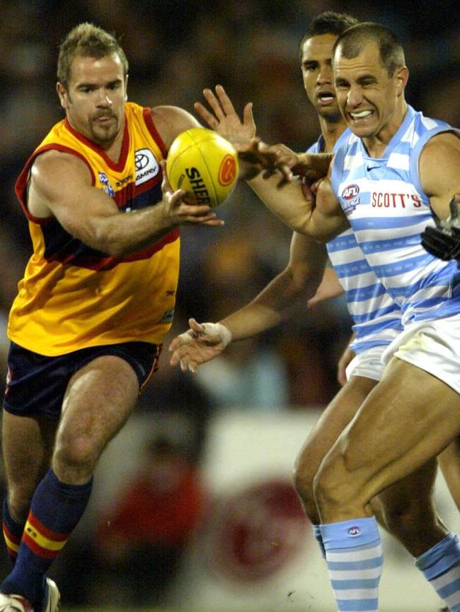 Mark Ricciuto steals the ball from Warren Tredrea in Showdown XVIII match at AAMI Stadium.