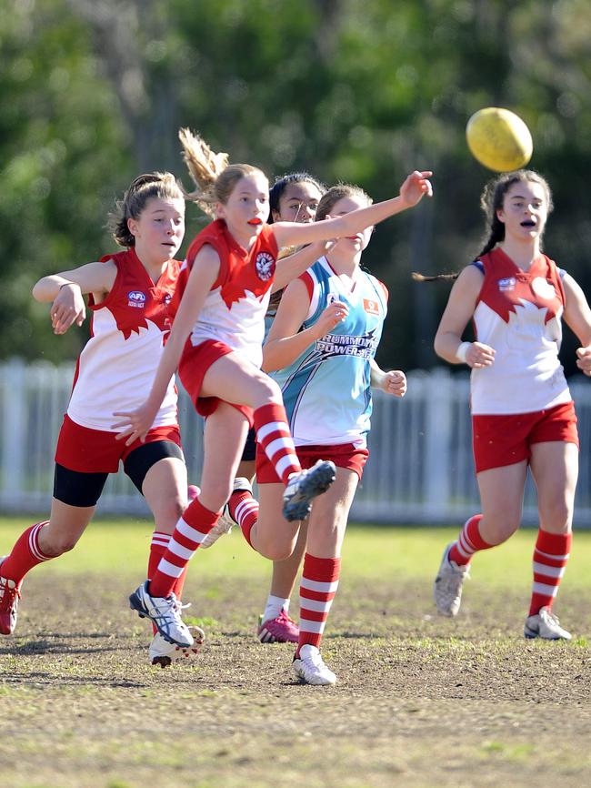 Mosman Swans and Drummoyne AFL players compete on the patchy surface of Middle Head Oval, Mosman in 2014.