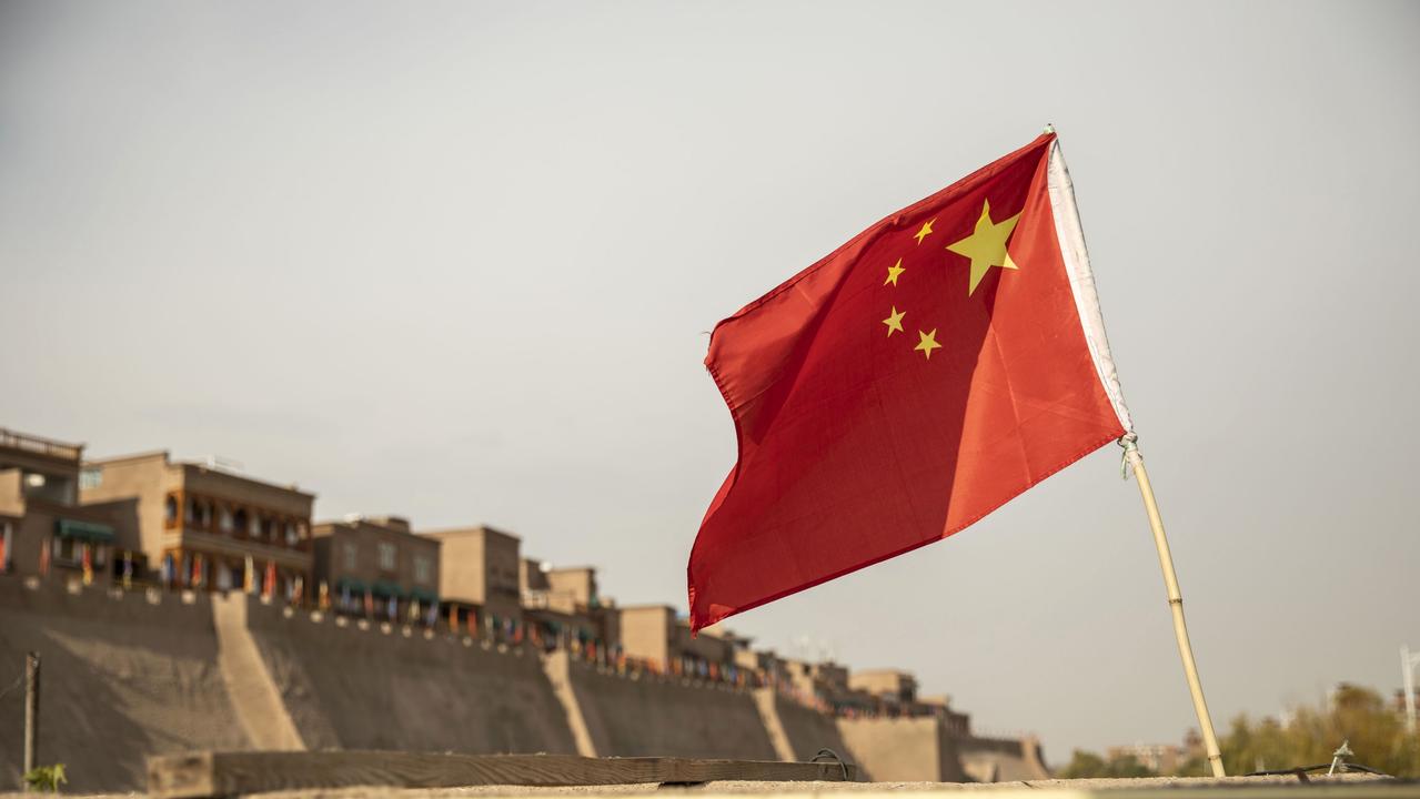 A Chinese flag flies outside the east gate of the Old City in Kashgar, Xinjiang. Source: Bloomberg