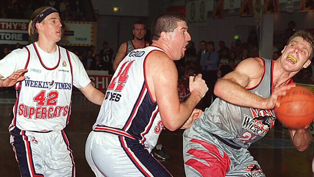 Jason Joynes stands over Perth's Andrew Vlahov in the NBL.