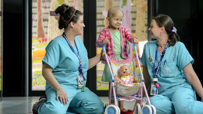 Maya Oldroyd in 2013 when she was undergoing cancer treatment, with Registered Nurses, Emma Brimmell and Tegan Dunmall.