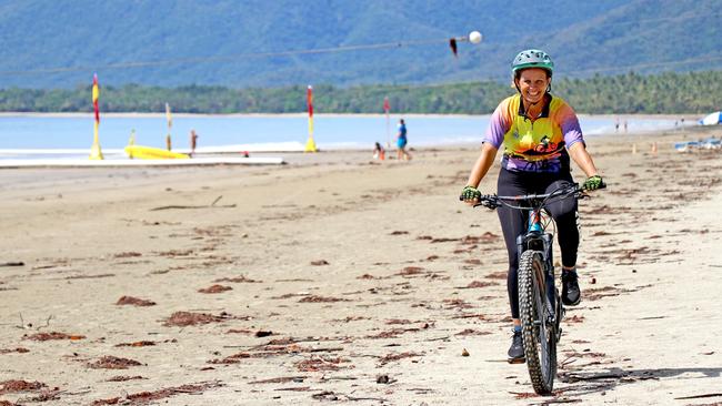 Angie Johnson from Bike Shop and Hire Port Douglas, rides along Four Mile Beach where the Wangetti Trail will end. Picture: GIZELLE GHIDELLA