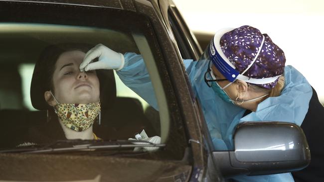 A woman takes a COVID-19 test in a test site at Werribee Plaza in Hoppers Crossing, Melbourne. Picture: NCA NewsWire / Daniel Pockett