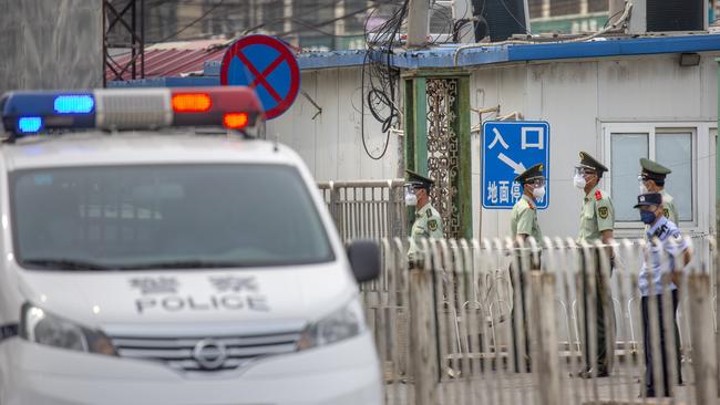 Paramilitary police stand guard on a street near the Xinfadi wholesale food market. Picture: AP