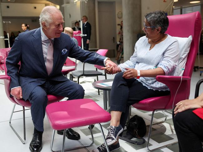 King Charles holds the hand of patient Asha Millan, during a visit to the University College Hospital Macmillan Cancer Centre in London. Picture: AFP