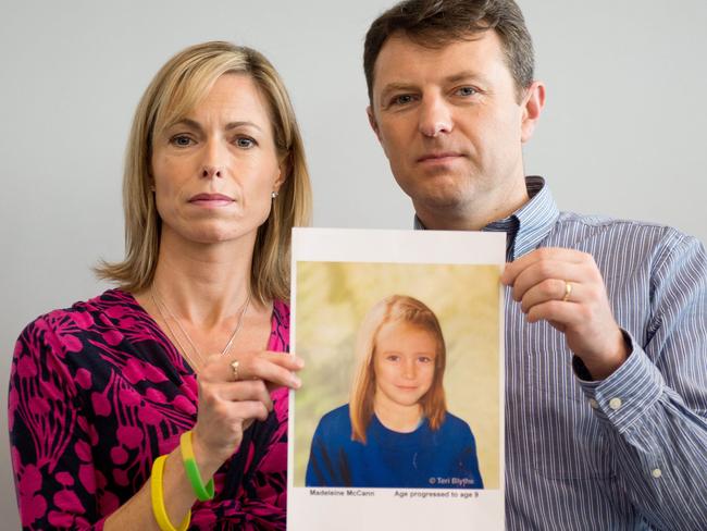 Parents of missing girl Madeleine McCann, Kate (L) and Gerry McCann (R) pose with an aged impression of what their daughter might look now. Picture: AFP