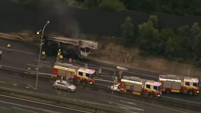 A crane driver escaped after a fire in the engine of his truck along the M2 at North Rocks. Picture: 9 News