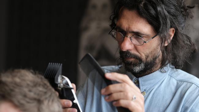 Three Thirds Barber Lounge owner Spencer Reid at work. Picture: LUKE BOWDEN