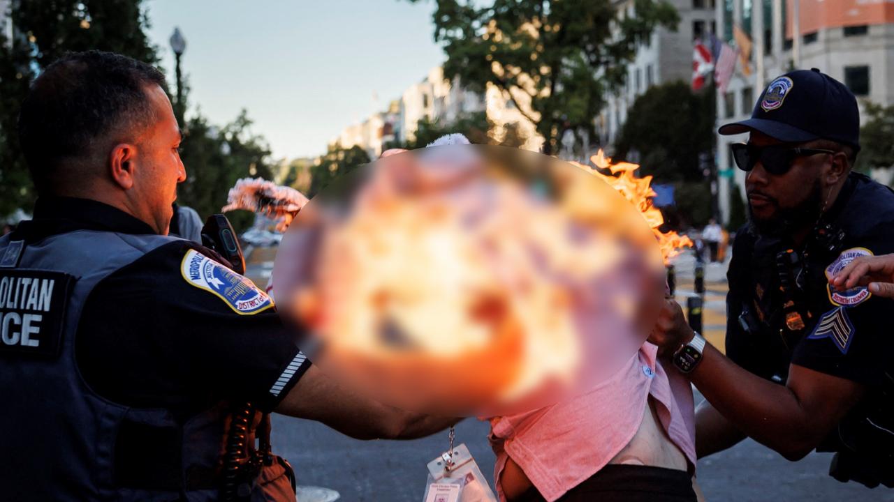 Police helping Mena. Picture: Ting Shen/AFP