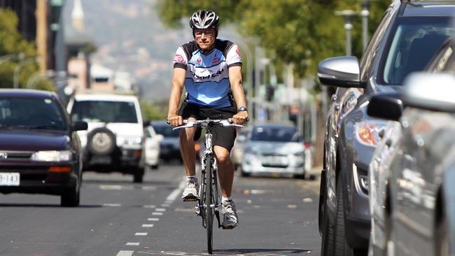 A cyclist keeps a safe distance from cars on Franklin Street.