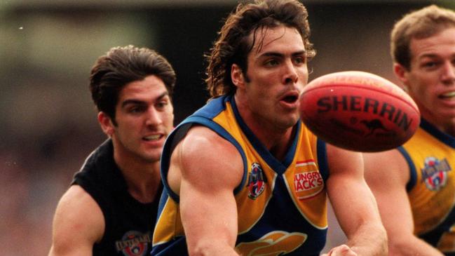 Drew Banfield handballs during West Coast’s 1996 semi-final against Essendon.