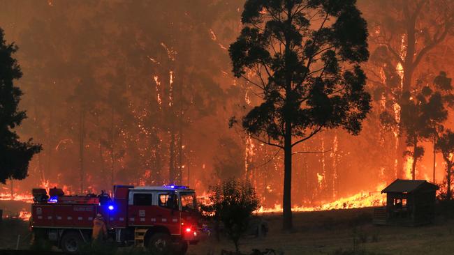 Fire crews attempt to hold back a blaze advancing towards the East Gippsland town of Bruthen on Monday night. Picture: Aaron Francis