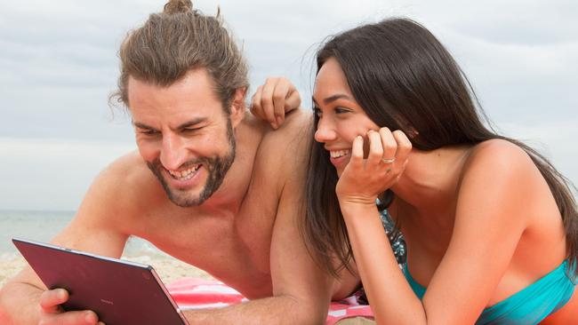 Generic photo supplied by Telstra of couple/people using a mobile device/tablet/smartphone