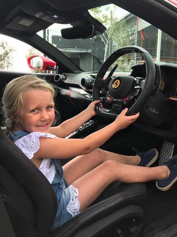 Five-year-old Maddison Houston behind the wheel of the Ferrari. Photo: Seven.