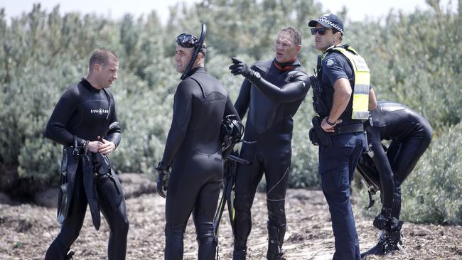 Police divers discuss the search. Picture: David Geraghty