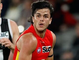 MELBOURNE, AUSTRALIA - APRIL 08: Elijah Hollands of the Suns is chased by Callum Wilkie of the Saints during the 2023 AFL Round 04 match between the St Kilda Saints and the Gold Coast Suns at Marvel Stadium on April 8, 2023 in Melbourne, Australia. (Photo by Michael Willson/AFL Photos via Getty Images)