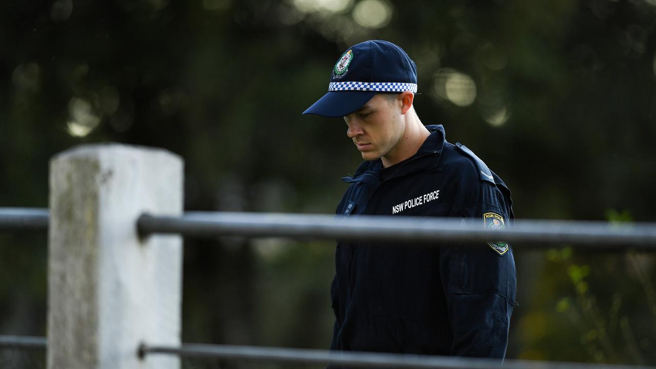 Police are seen searching the front yard of the house on Taylors Road, Dural.