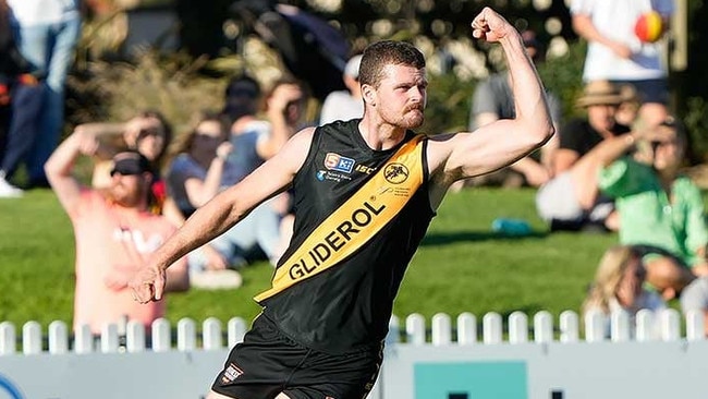 Nic Minchin celebrates a goal while playing for Glenelg,