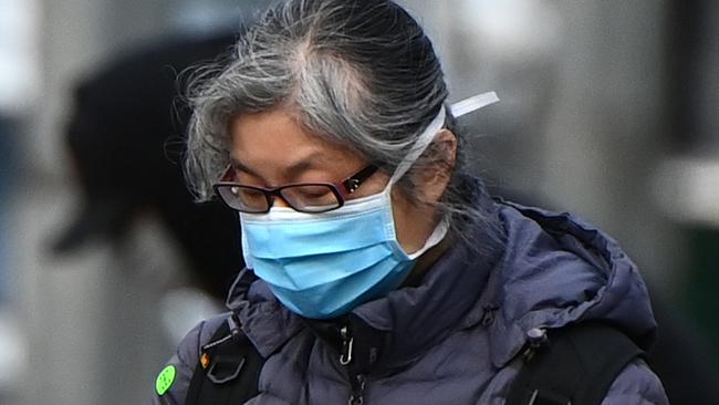 A woman wearing a face mask walks through the city on July 20, 2020 in Melbourne, Australia. Picture: Getty Images