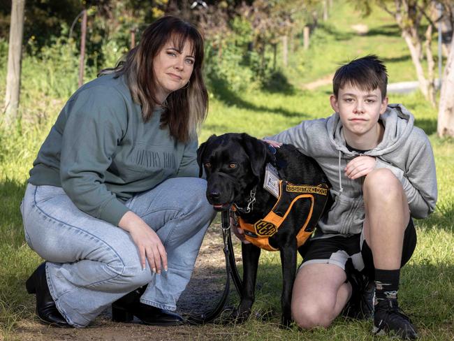 ADELAIDE, AUSTRALIA - Advertiser Photos AUGUST 26, 2023: Zak Lawrence 15yrs with his mother Caroline McCudden and their assistance dog Blaze at home in . Enfield, SA. Picture: Emma Brasier