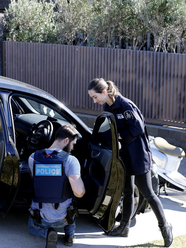 An Audi out the front of John Ibrahim’s home is searched by police.