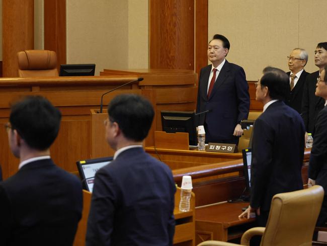 Yoon Suk Yeol (C) stands as he attends the fourth hearing of his impeachment trial over his short-lived imposition of martial law at the Constitutional Court in Seoul. Picture: AFP