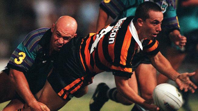 Jason Webber of Balmain) is tackled by Graham Mackay.