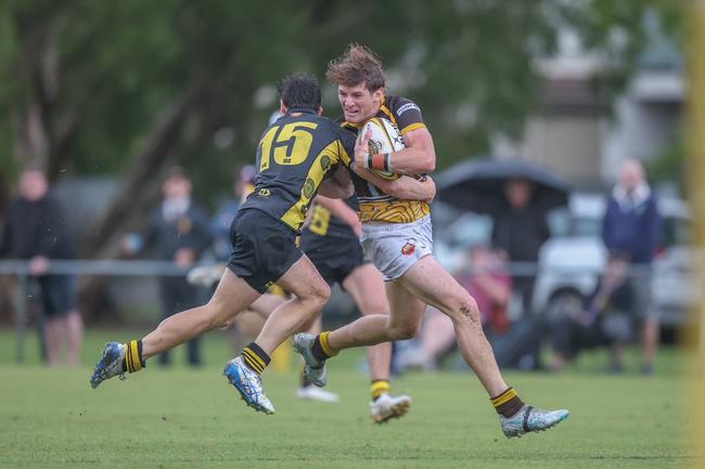 Nate Clark is wrestled to ground by Harry Taylor (No. 15).